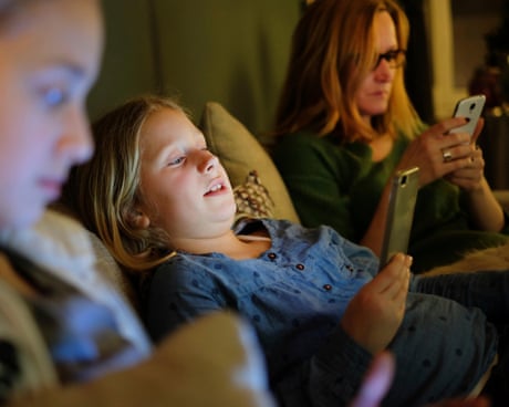 Mother and children busy with their mobile phones