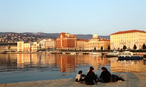 Young people sitting on the pier in Trieste