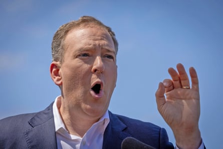 a man in a suit speaks outside