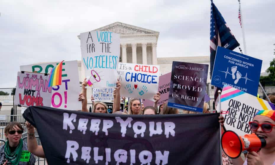 Pro-choice and anti-abortion demonstrators gather outside the US supreme court on Tuesday.