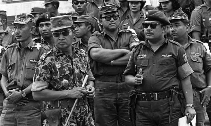 Gen Suharto, left, and Gen. Sabur, right, at the funeral of six army generals