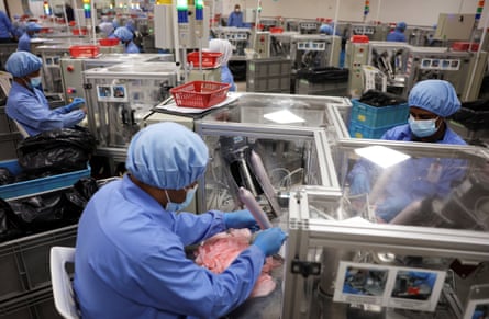 Rows of workers behaviour tests connected condoms astatine nan condom shaper Karex’s installation successful Malaysia