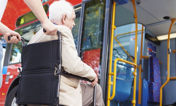A wheelchair user boards a bus