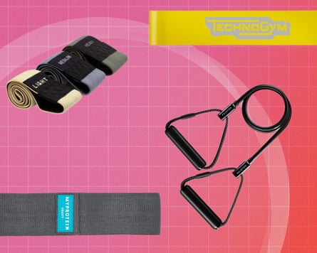 Fabric resistance loop bands and a handled resistance band on a pink grid background