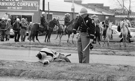 A freedom marcher lies unconscious in Selma, Alabama, after being attacked by the police.