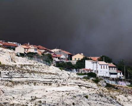 Houses with black smoke behind