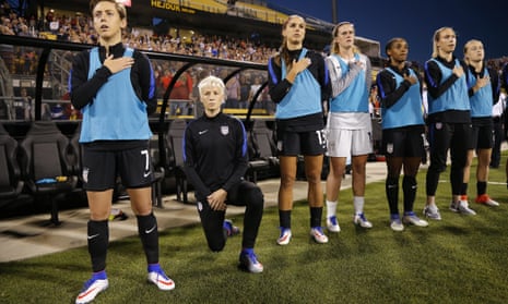United States’ Megan Rapinoe, second from left, kneels before the Thailand game.