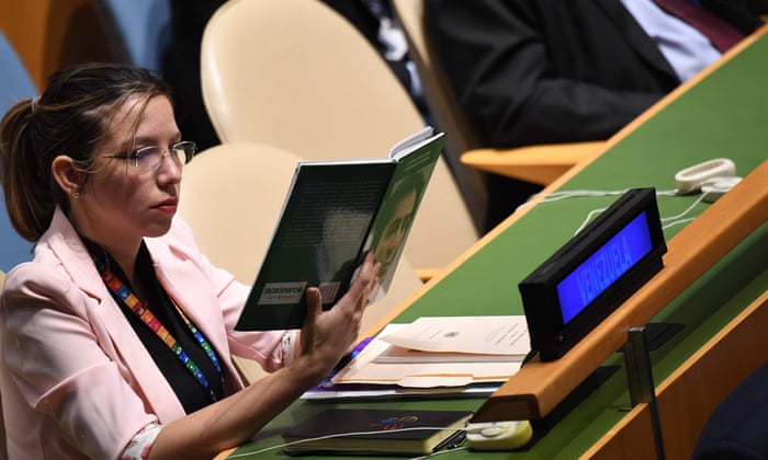 A delegate from Venezuela looks at a book during US President Donald Trump’s address at the 74th Session of the United Nations General Assembly at UN Headquarters in New York