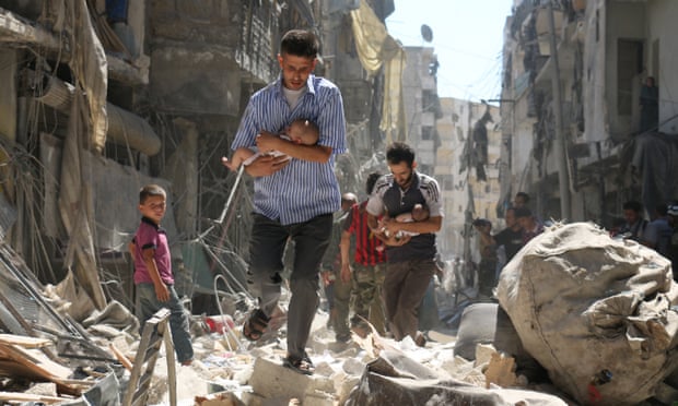Syrian men cradle babies as they navigate the rubble of destroyed buildings after an air strike on Aleppo’s Salihin district in September 2016