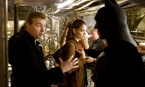 A very different future ... Christopher Nolan, Katie Holmes and Christian Bale on set of Batman Begins in 2005.