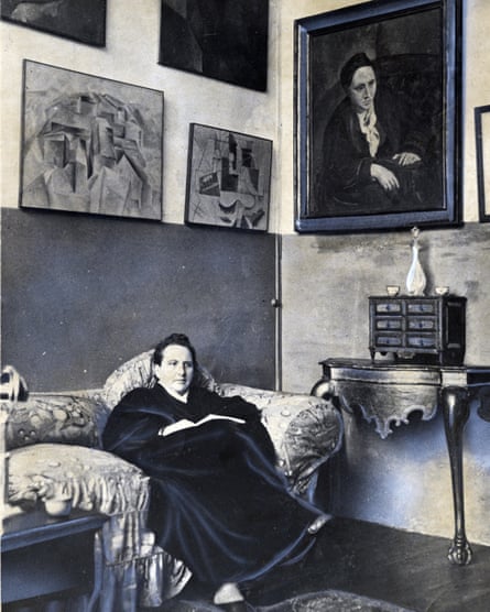 Gertrude Stein sitting on a sofa in her Paris studio.