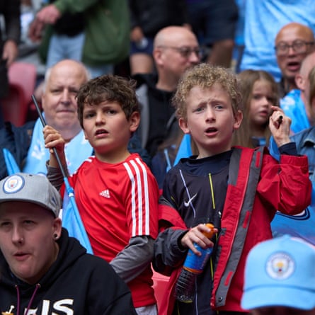 Man City fans look worried after Chelsea score their first goal.