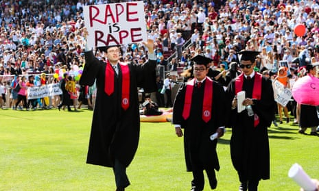 Stanford student Paul Harrison carries a sign in a show of solidarity for a Stanford rape victim during graduation ceremonies in Palo Alto, California on 12 June 2016. 