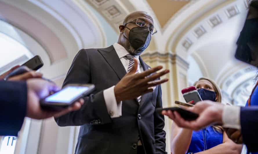 First Thing: Senate gets $1tn infrastructure bill over the line | 1 Senator Raphael Warnock, a key figure on voting rights efforts, speaks to reporters at the Capitol in Washington.