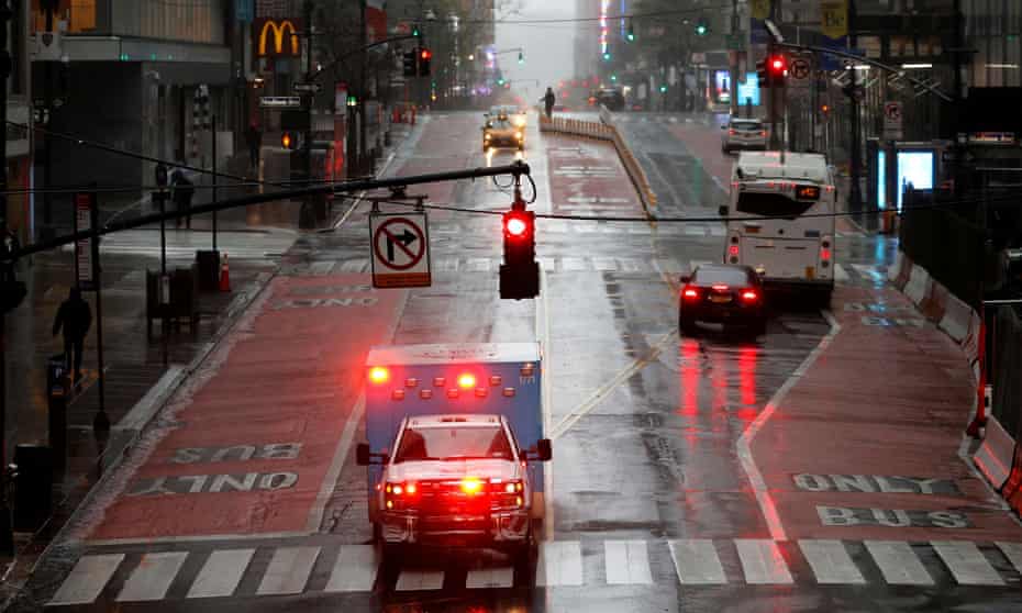 An ambulance drives across a nearly empty East 42nd Street in Manhattan during the outbreak of the coronavirus disease.