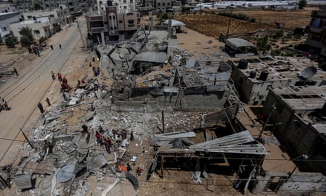 Palestinians search among the rubble of a destroyed home, following an Israeli air strike in Rafah, in the southern Gaza Strip. 