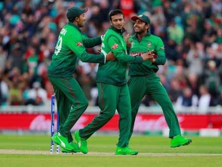 Bangladesh ‘s Shakib Al Hasan celebrates with team mates after taking the wicket of New Zealand’s Martin Guptill