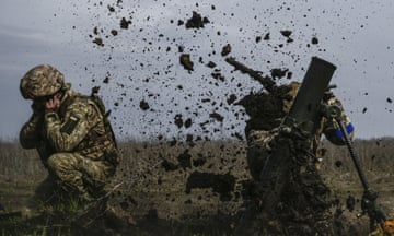 Ukrainian soldiers firing on the frontline in Donetsk