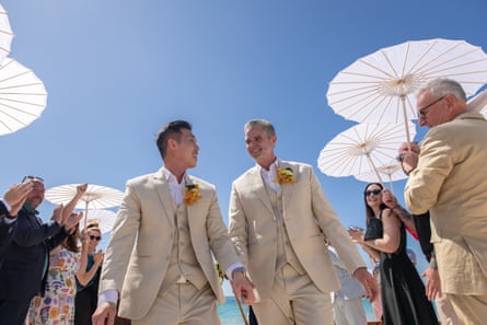 Two men wearing beige coloured suits on their wedding day.