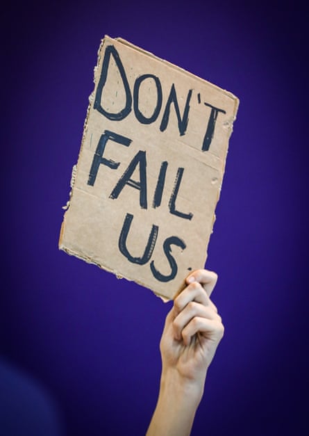 An activist at this month’s cop27 summit holds up a placard urging leaders to abide by the 1.5c pledge