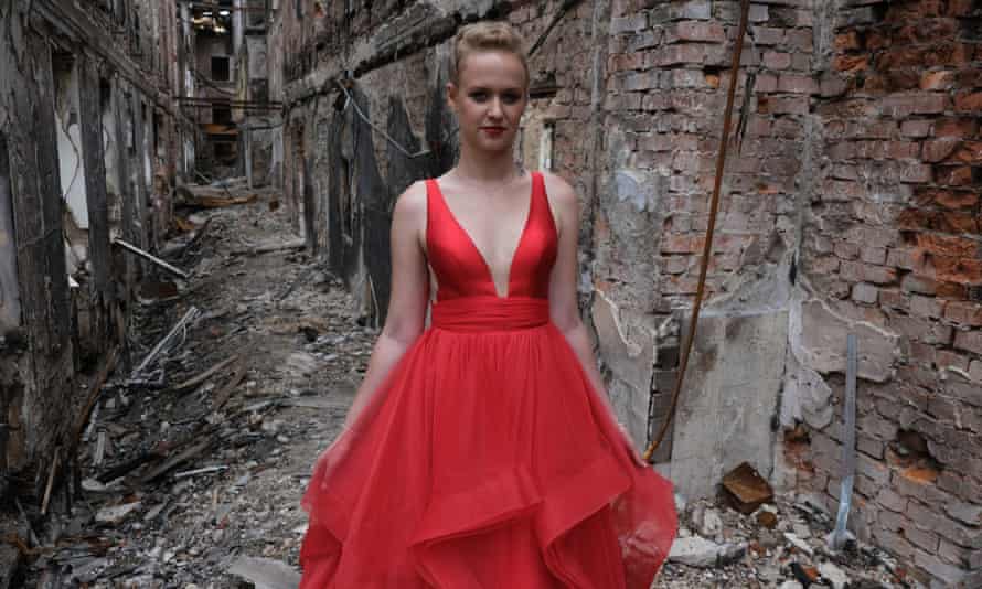 A student wearing her prom dress poses for a photo among the ruins of her school destroyed in a Russian shelling on 27 February 27, in Kharkiv, Ukraine.
