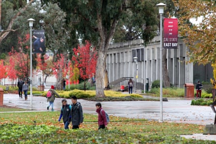 Students walk on the campus of Cal State East Bay in Hayward, Calif.