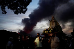 Residents walk in a procession with the Virgen del Pino around its chapel to pray for the volcano to stop