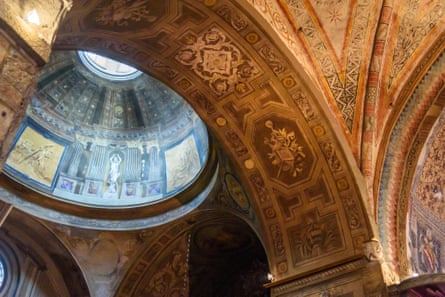 Art on walls of old cathedral with a dome