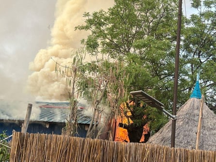 Fire and smoke can be seen coming from a building