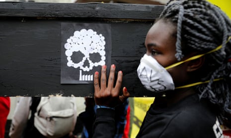 A campaigner carries a coffin during a protest against the construction of a coal plant in Lamu on Kenya’s coast, in Nairobi on June 12, 2019.
