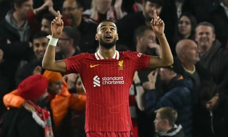 Cody Gakpo points upwards after scoring his second goal of the game for Liverpool