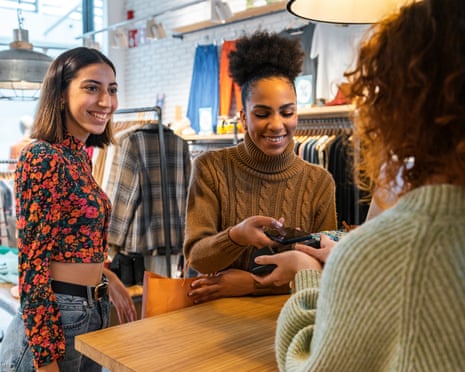 Two female customers paying at independent boutique