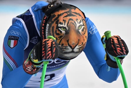 Federica Brignone shows off the tiger image on her helmet and gloves after skiing during the women’s downhill training