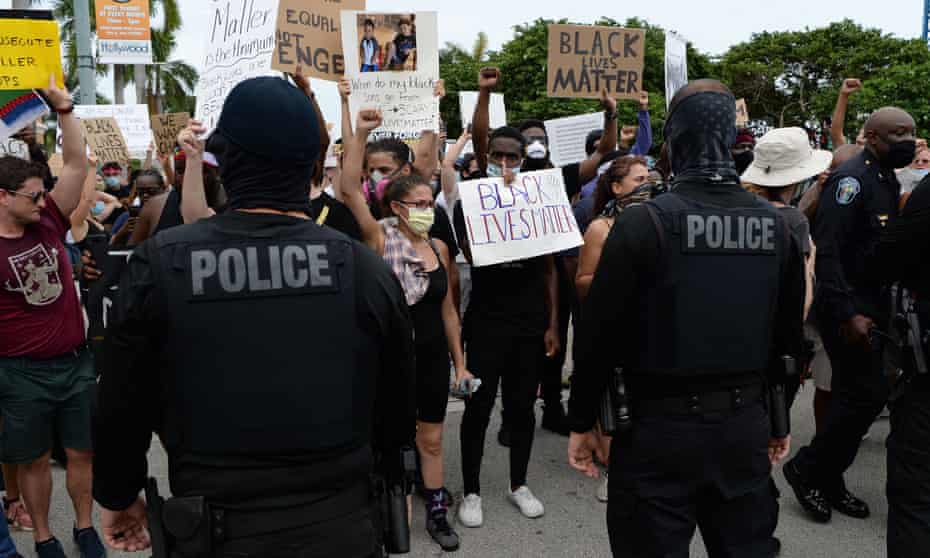 Protesters are confronted by police officers as they demonstrate peacefully for George Floyd on 7 June. 