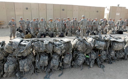 US soldiers of the 1st Battalion, 116th Infantry Regiment, wait to load their luggage as they prepare to pull out from Iraq and leave for Kuwait from Tallil airbase near Nasiriya, 220 miles southeast of Baghdad, on 15 August 2010.