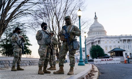 National guard troops stand outside the US Capitol on Wednesday as the House considers impeachment.