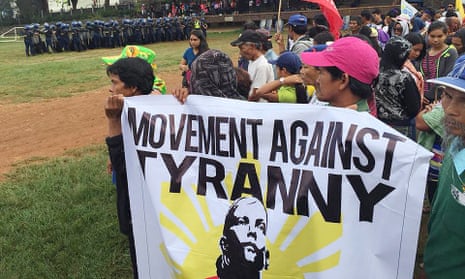 Police train beside members of the Movement Against Tyranny in Baguio city