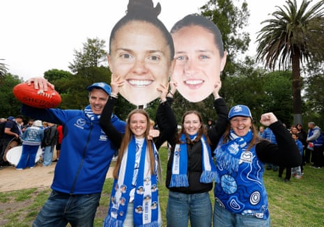 North Melbourne fans pose with signs ahead of the 2025 AFLW grand final