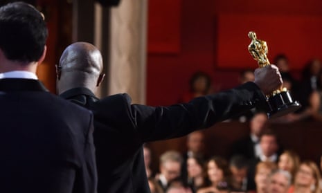 Barry Jenkins with his Oscar for best picture. In the foreground is La La Land’s director, Damien Chazelle. 