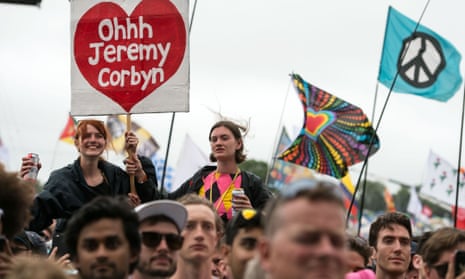 Music fans listen as Jeremy Corbyn addresses the crowd from the Pyramid Stage during Glastonbury 2017
