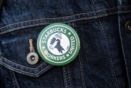 close up of a denim jacket with a badge saying starbucks workers united