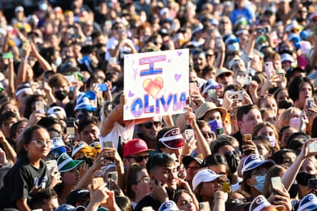 fans hold a sign that says ‘I heart Olivia’