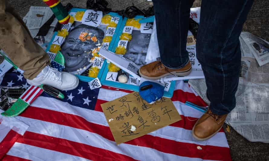 Pro-China activists step on photographs of US President Donald J. Trump and US Secretary of State Mike Pompeo, outside the US Consulate in Hong Kong