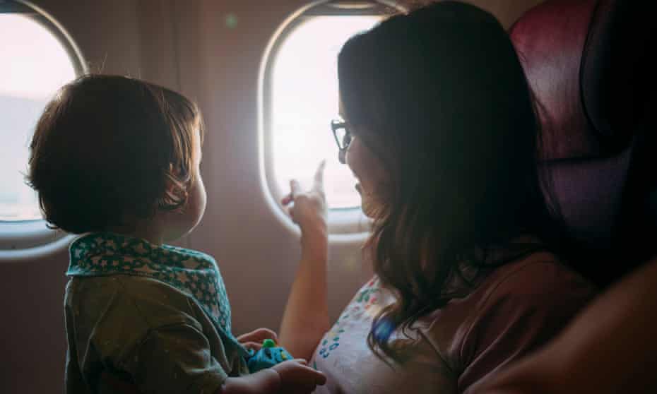 Mother and infant daughter on a plane (posed by models)