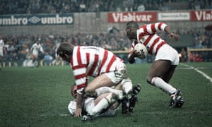 Wigan’s Ellery Hanley makes a run while teammate Graeme West pins his man