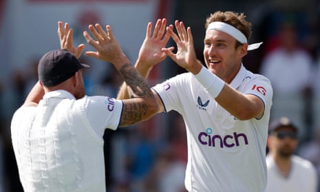 Stuart Broad celebrates his landmark wicket with his captain.