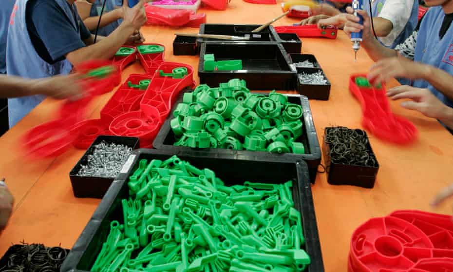 Labourers work at a toy factory in Panyu, south China’s Guangdong province