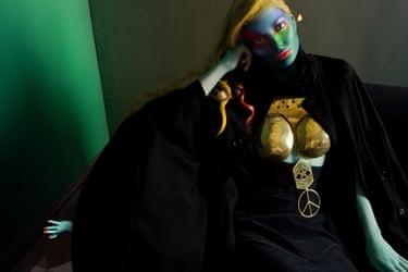 Eniko Mihalik in vibrant facepaint and a surreal warrior costume