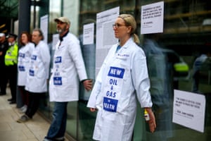 Activists from Extinction Rebellion who glued themselves to an entrance at the Department for Business, Energy and Industrial Strategy in London today.