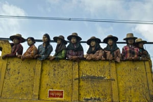 Labourers ride in a truck on their way to work on the outskirts of Yangon, Myanmar.